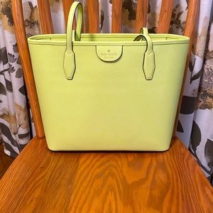A brand new Kate Spade used twice. It’s a pastel green and very roomy inside.